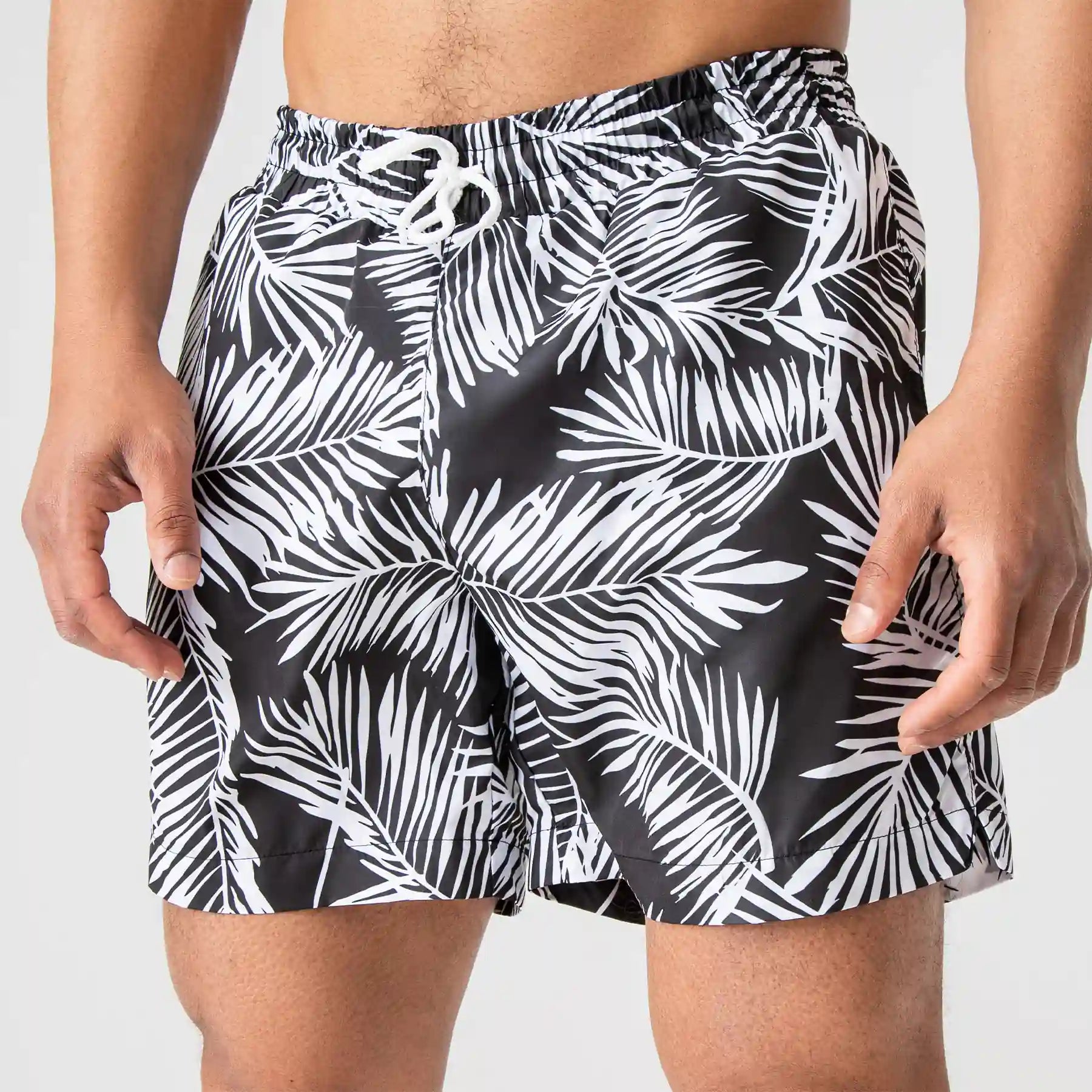 Man’s SET black anatomic swim shorts with palm leaf print, lightweight men’s summer beachwear, front view