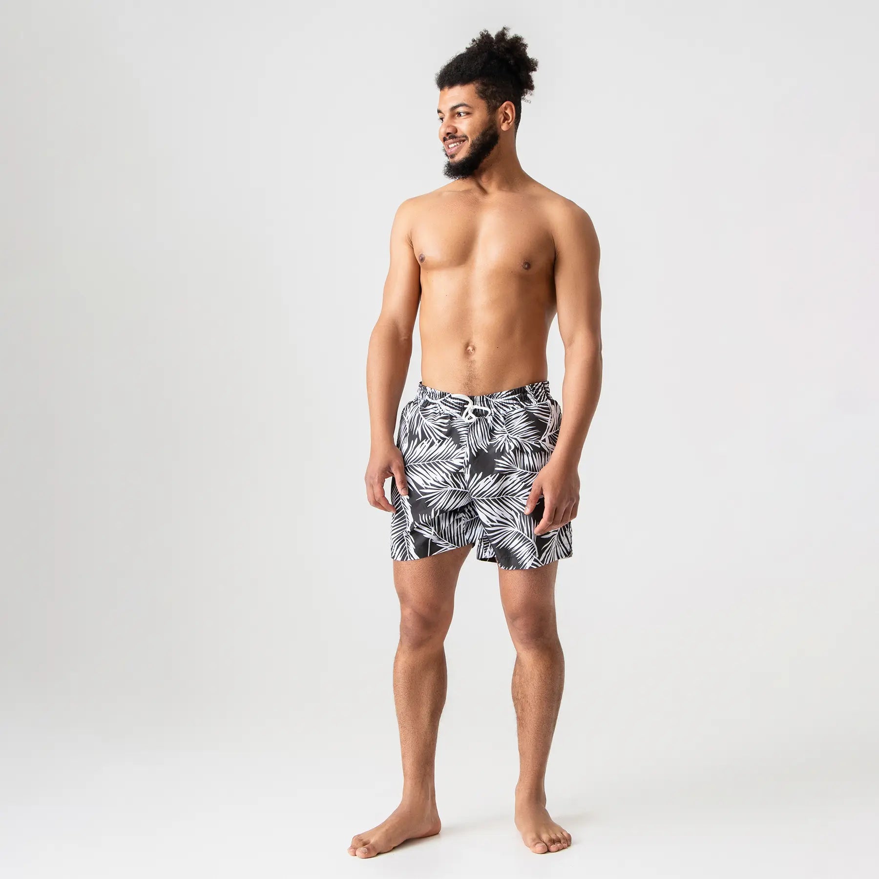 Man’s SET tropical black swim shorts with palm leaf print, lightweight summer swimwear, front view