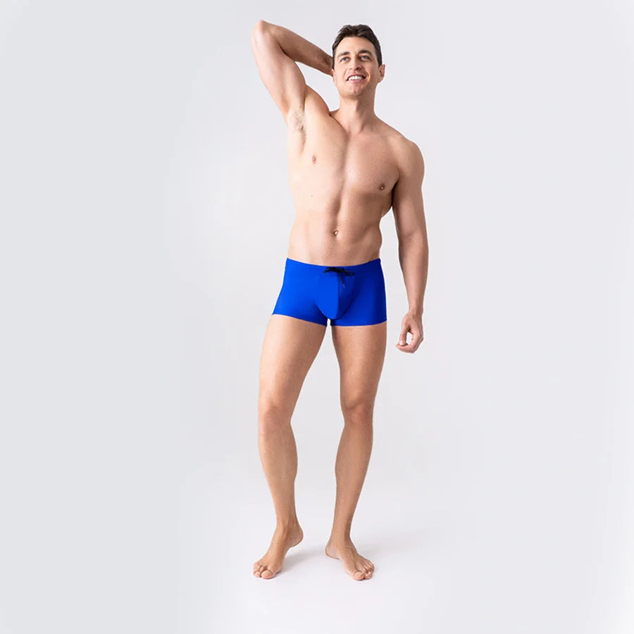 Blue anatomical swim trunks by Man’s SET with ball-support pouch and drawstring waist, front view